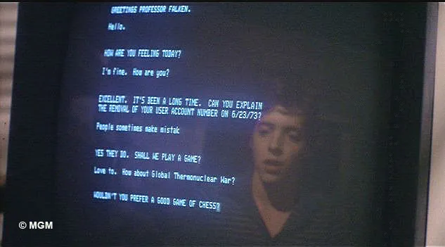 A terminal from Wargames, with monochrome blue text, and Matthew Broderick’s face reflected in the screen